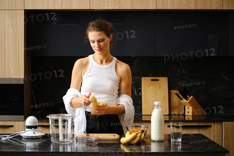 Preparation of nutritious banana and sea buckthorn smoothies in a modern kitchen setting