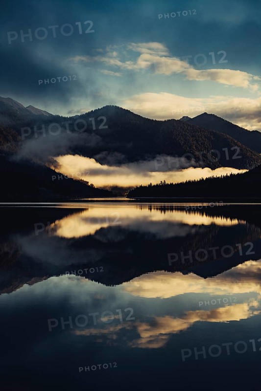 Sunrise with reflections in the Plansee in Tyrol in the Alps in Austria