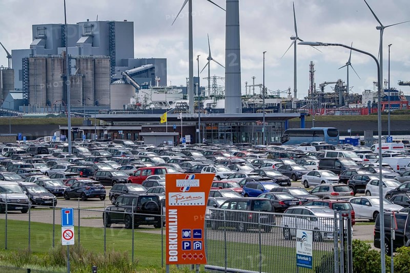 Car park at the ferry port of Eemshaven, in the Ems estuary ferry to the German North Sea island of Borkum, by AG Ems Nederland B.V., Borkumlijn, short and long-term car park, industrial port, power plants, wind farm, Netherlands
