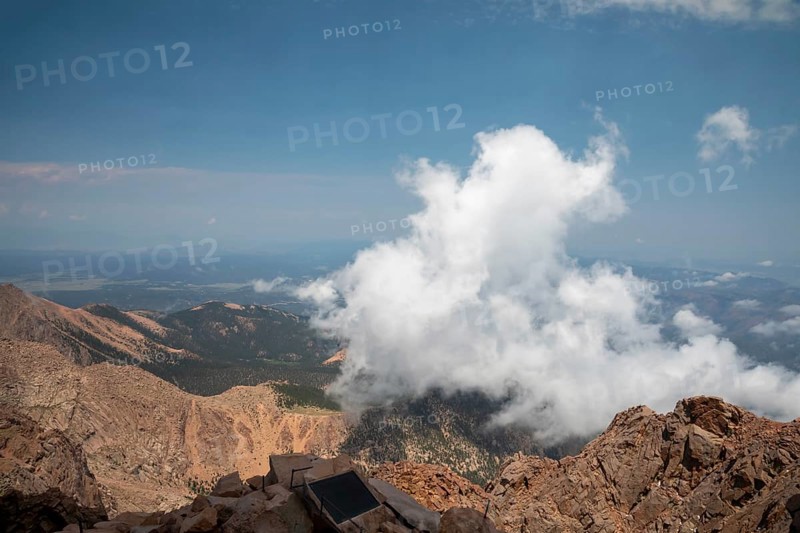 Colorado Springs, Colorado - Clourds rise near the summit of Pikes Peak, a 14, 115' mountain in Colorado's front range. Thousands of tourists visit, most by driving a steep road to the summit, or riding on a cog railway