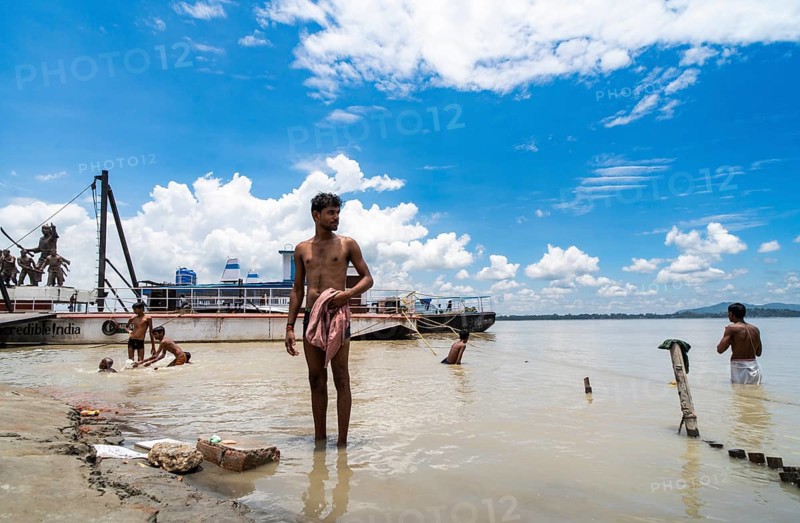 People bathe in the Brahmaputra River to seek relief from the intense summer heat in Guwahati, India, on June 26, 2025