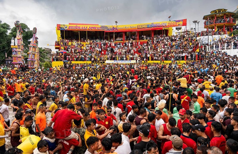 People from the Pnar community march in a circle as they celebrate an event organized to mark the Behdienkhlam festival in Jowai, India on July 14, 2025. Behdienkhlam is a vibrant annual festival celebrated by the Pnar (Jaintia) community of Meghalaya, especially in Jowai, to drive away plague and diseases and to pray for a good harvest. Observed in July after the sowing season, it features traditional rituals, offerings to ancestral spirits, and the grand procession of beautifully decorated bamboo structures called rots, which are later immersed in a sacred muddy pool known as Ka Aitnar