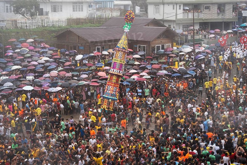 People from the Pnar community march in a circle around a Rot as they celebrate an event organised to mark the Behdienkhlam festival in Jowai, India on July 14, 2025. Behdienkhlam is a vibrant annual festival celebrated by the Pnar (Jaintia) community of Meghalaya, especially in Jowai, to drive away plague and diseases and to pray for a good harvest. Observed in July after the sowing season, it features traditional rituals, offerings to ancestral spirits, and the grand procession of beautifully decorated bamboo structures called rots, which are later immersed in a sacred muddy pool known as Ka Aitnar