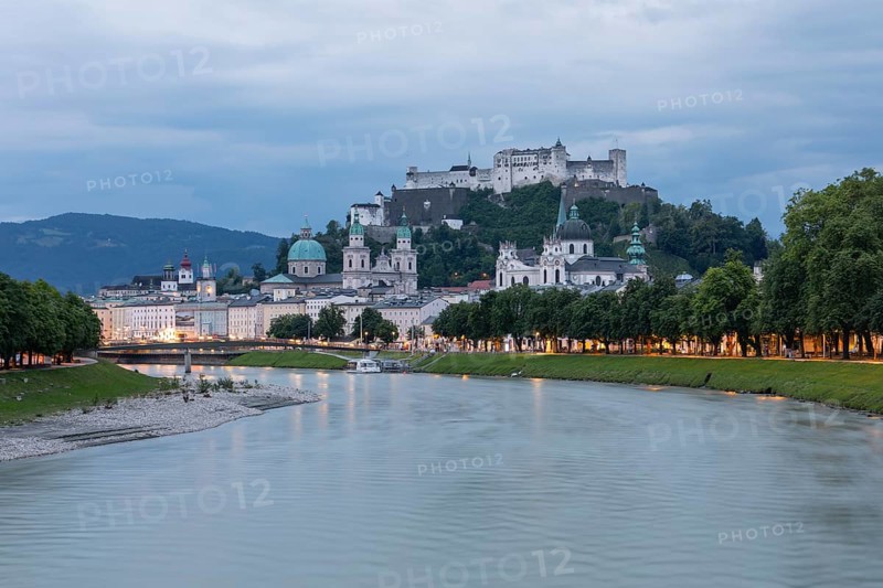 The city of Salzburg with the Salzach shines in the first light of summer morning