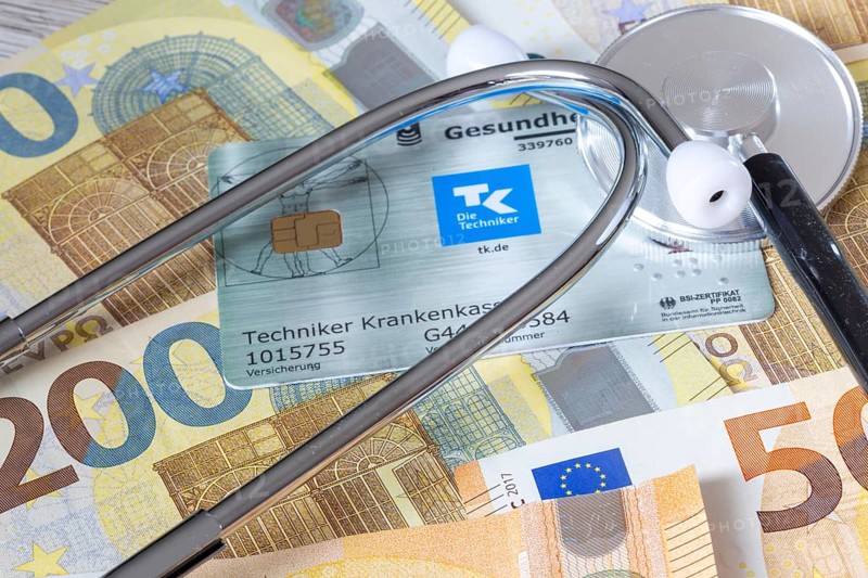 Health insurance contributions Symbolic image: health card, stethoscope and cash