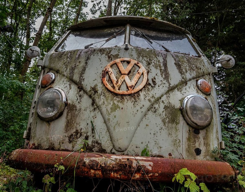 Old, weathered VW bus parked in a wooded area, Hesse, Germany