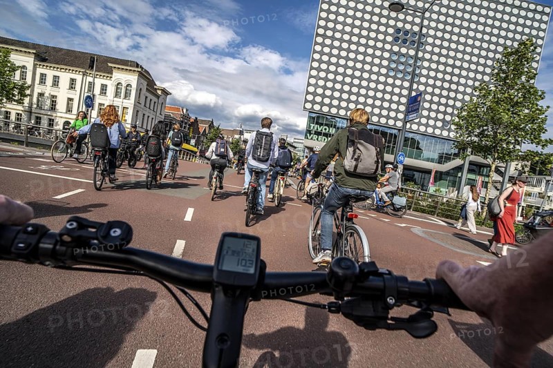 Ride your bike on the central cycle path on Lange Viestraat, Vredenburg, in the city centre of Utrecht, lanes for pedestrians, cyclists and public transport vehicles are separated, heavy cycle traffic, Netherlands