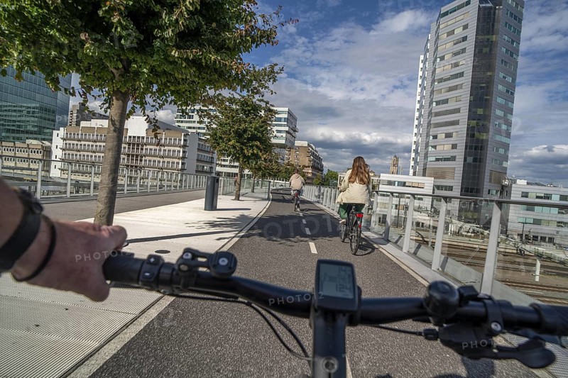 Cycling over the Moreelsebrug, pedestrian and cyclist bridge over the tracks of Utrecht Centraal, Central Station, Rabobank