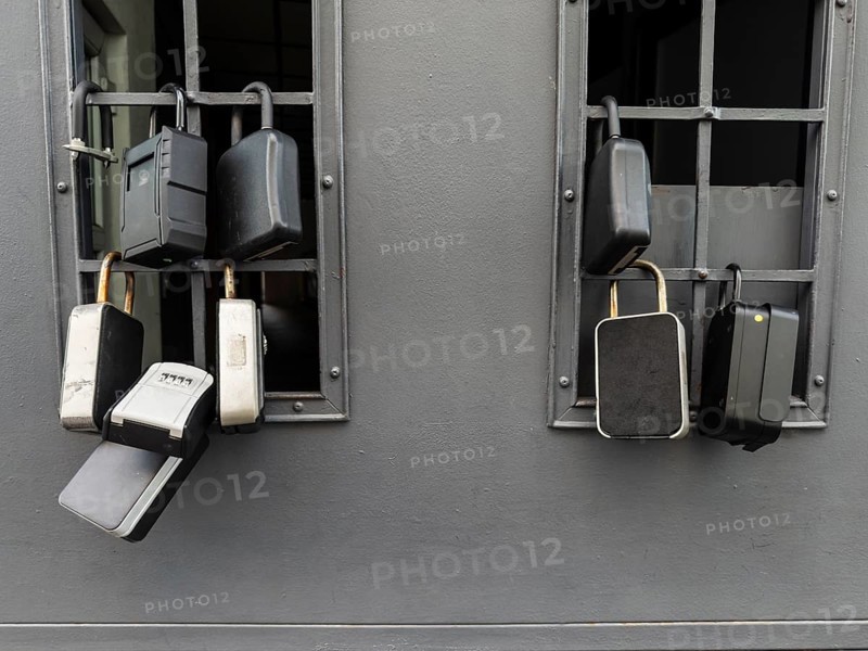 Key boxes on a grille of a basement window for flat flats in the city centre of Bratislava, Slovakia