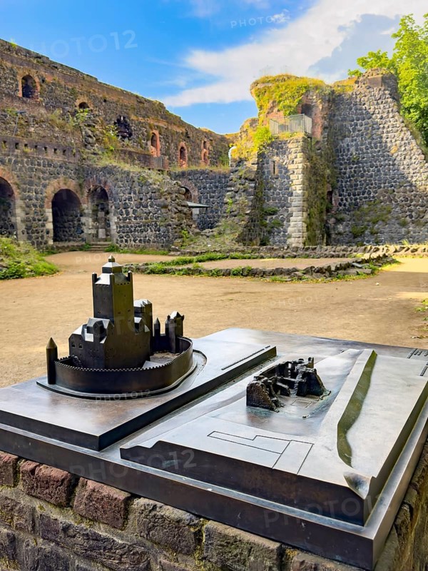 In front left small metal model of the original fortress building of the imperial palace of Emperor Frederick I Barbarossa, built in the Middle Ages around 1184 on today's banks of the Rhine, right next to it for direct comparison model of today's ruin, in the background part of ruin, Kaiserswerth, Düsseldorf, North Rhine-Westphalia, Germany