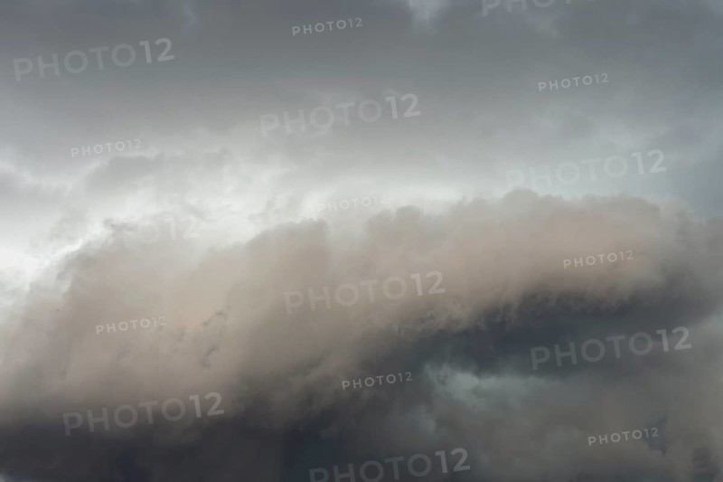 Below dark discoloured storm clouds Cloud roll above grey clouds Rain clouds heralding thunderstorms, Germany