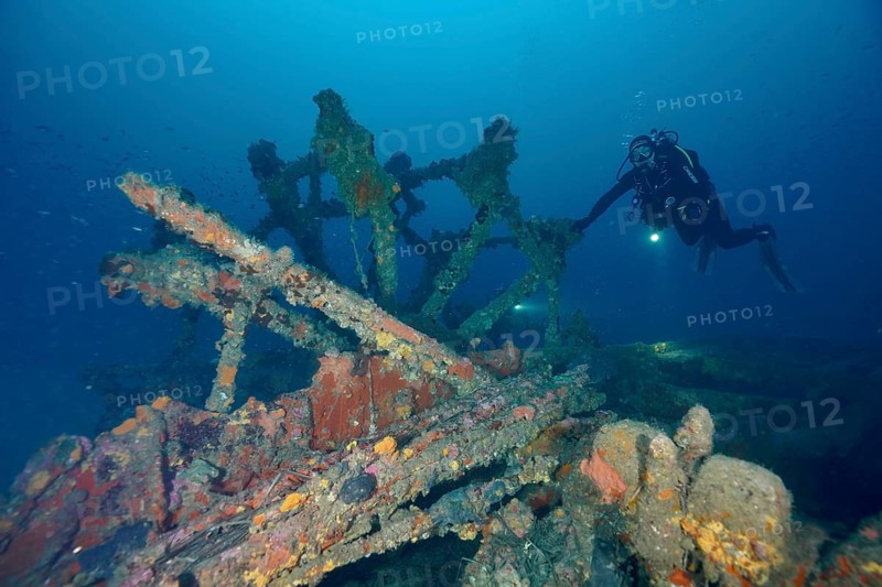 Diver examines the remains of an old shipwreck. Dive site wreck Ville de Grasse, Giens peninsula, Mediterranean Sea, Provence Alpes Côte d'Azur, France