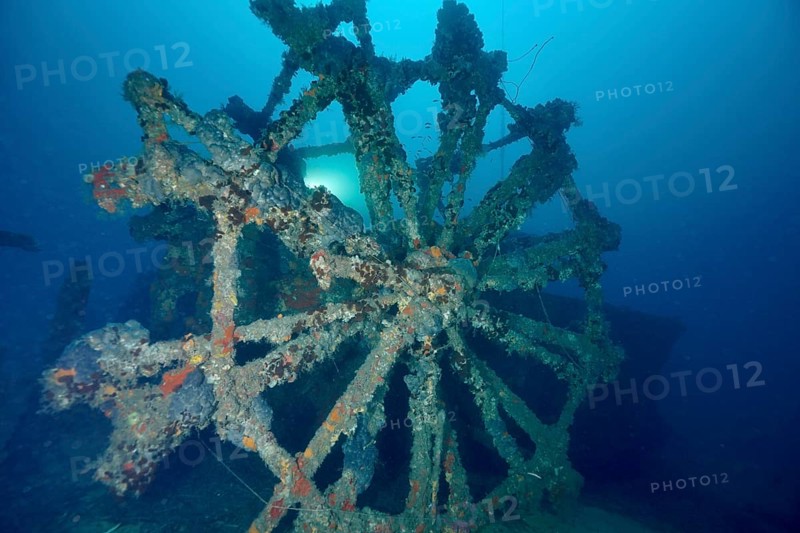 Dilapidated paddle wheel of a shipwreck in blue surroundings. Dive site wreck Ville de Grasse, Giens peninsula, Mediterranean Sea, Provence Alpes Côte d'Azur, France