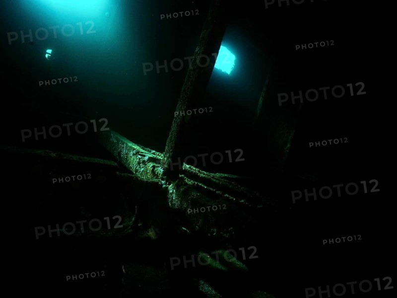 A mysterious, dark room in the shipwreck with blue light and shadows. Dive site wreck of the Cimentière, Giens peninsula, Mediterranean, Provence Alpes Côte d'Azur, France