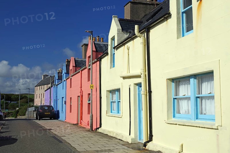 Brightly coloured house facade in sunny weather along a quiet street, Scalloway, Shetland Islands, Scotland, United Kingdom