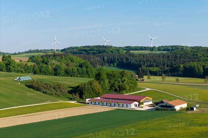 Idyllic rural scene with windmills, green fields and a farm under a blue sky, near Westerheim, Swabian Alb, Baden-Württemberg, Germany