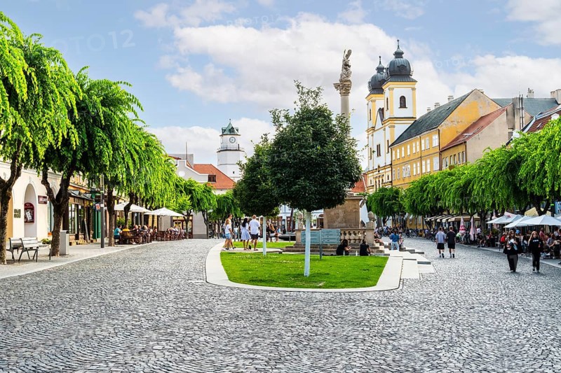 Peace Square with cafés in the old town of Trencin, in the background the Piarist Church of St Francis Xavier, Capital of Culture 2026, Trencín, Slovakia