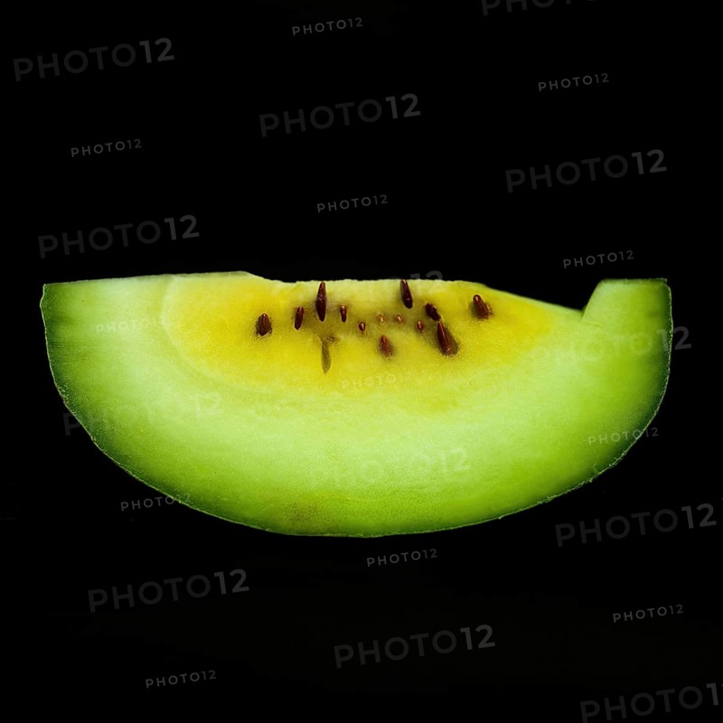 A vibrant slice of watermelon sits against a sleek black background, showcasing its juicy red flesh and contrasting green rind. This refreshing fruit symbolizes summertime and healthy eating