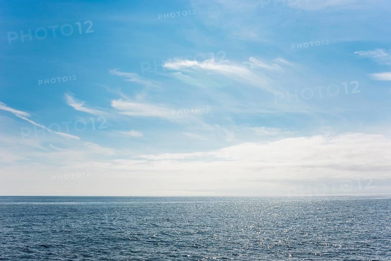 Dark ocean under a clear blue sky with bright white feathery clouds, cloud bank, horizon, water with light reflections, dark blue, light, reflection, sunny, water surface, summer, sunny, weather, calm sea, vastness, horizon, landscape, maritime, nature, relaxation, recreation, sunlight, freedom, sea voyage, too: threatening emptiness, being lost, infinite, infinity, nobody, alone, loneliness, journey with the Halunderjet from Heligoland to Hamburg, German Bight, North Sea, Germany