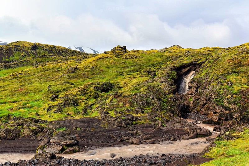 Barren moss-covered volcanic landscape, stream, Arnarstapi, Snaefellsjökull volcanic system, Snaefellsnes peninsula, West Iceland, Iceland