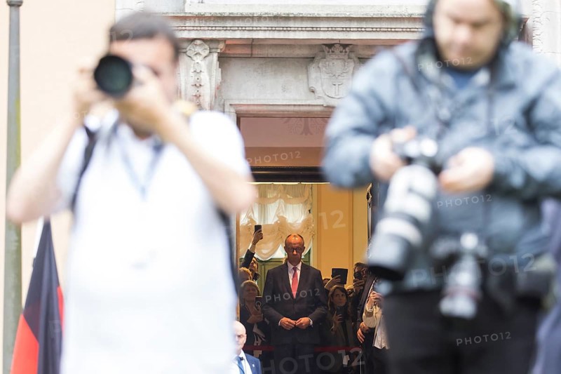 Friedrich Merz (CDU, German Chancellor) waits behind photographers for Emmanuel Macron (President of the French Republic) in front of a joint meeting at Villa Borsig in Berlin on 23 July 2025