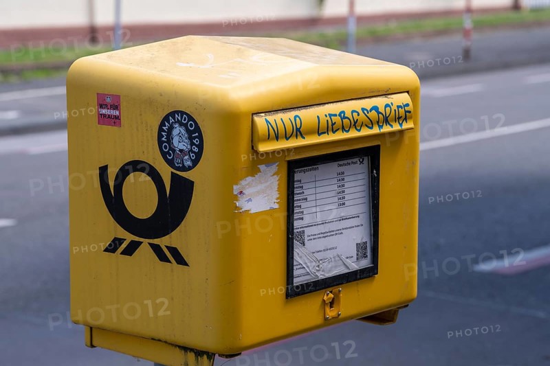 Deutsche Post letterbox, with stickers and graffiti, labelled Only love letters, Leverkusen, North Rhine-Westphalia, Germany
