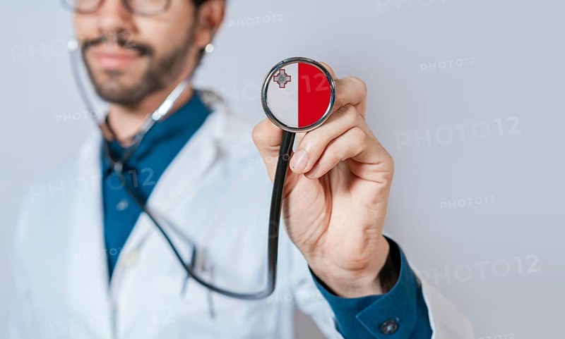 Doctor holding stethoscope with Malta flag. Malta health and care concept, Malta flag on stethoscope