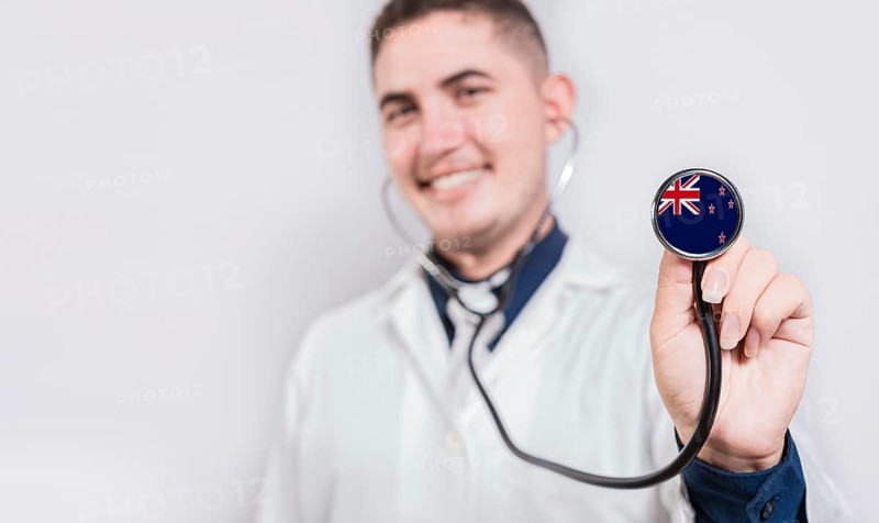 Doctor showing stethoscope with New Zealand flag. New Zealand national healthcare concept
