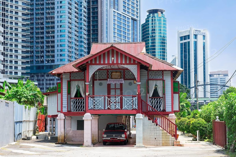 Traditional small house surrounded by modern skyscrapers, Kuala Lumpur, Malaysia, Asia