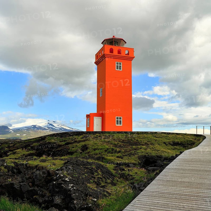 Orange lighthouse Skálasnagaviti or Svörtuloft with volcano Snaefell Snaefellsjökull glacier, Skalasnagi, Öndverdarnes, Snæfellsnes peninsula, Snaefellsnes, Iceland