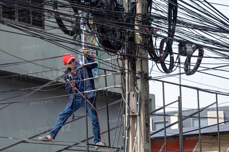 Craftsman welding metal rods, Bangkok, Thailand