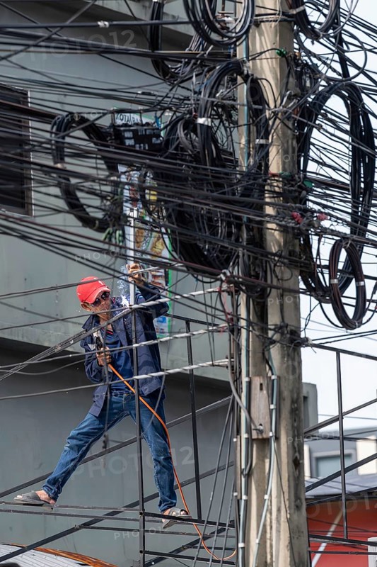 Craftsman welding metal rods, Bangkok, Thailand