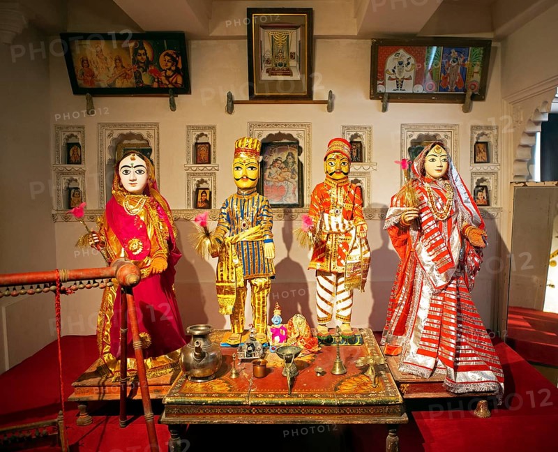 Indian traditional woman and men, dolls, worshipping Radha Krishna in the City Palace Museum, City Palace of Udaipur, Rajasthan, India