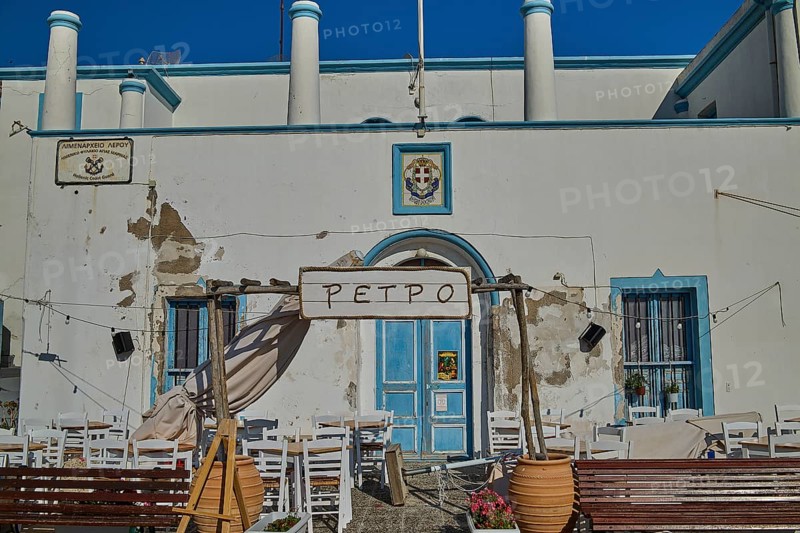 Outdoor terrace of a restaurant with blue and white façade and floral decoration, Agia Marina, Leros, Dodecanese, Greek Islands, Greece