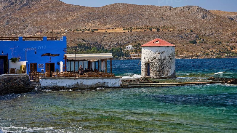 Restaurant Mylos, coastal village with windmill and blue buildings in front of mountain landscape, Agia Marina, Leros, Dodecanese, Greek Islands, Greece