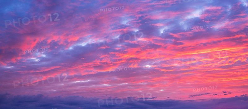 Background image for sky replacement, evening sky with illuminated red clouds at dusk after sunset