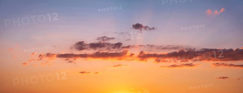 Wallpaper for sky replacement, evening sky with orange glowing clouds and sun rays at sunset