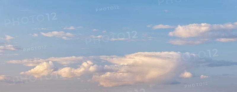 Wallpaper for sky replacement, blue sky with soft white clouds in the evening light