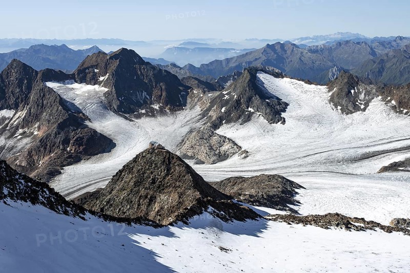 At the Wilder Freiger summit, picturesque high mountain landscape with snow, view of the Übeltalferner glacier and rocky mountain peaks Becher with Becherhaus and Königshofspitz, Stubai Alps, South Tyrol, Italy