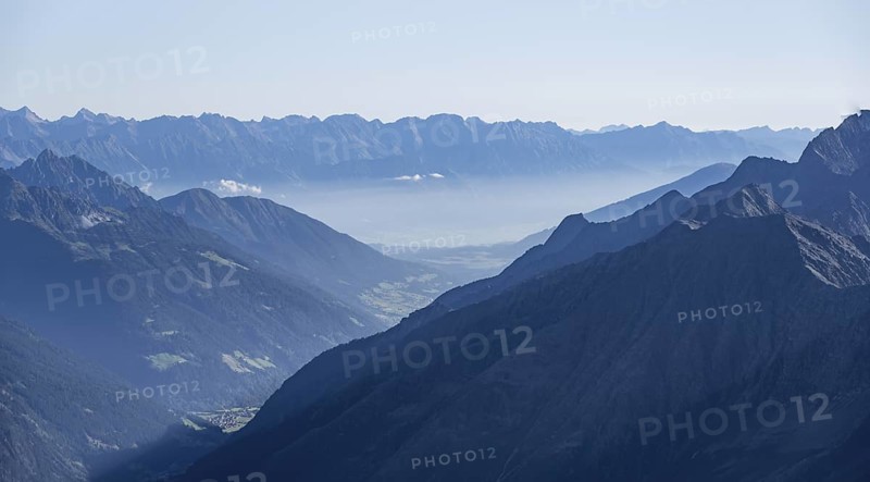 View of the Stubai Valley, mountain silhouettes, from the summit of the Wilder Freiger, Stubai Alps, South Tyrol, Italy