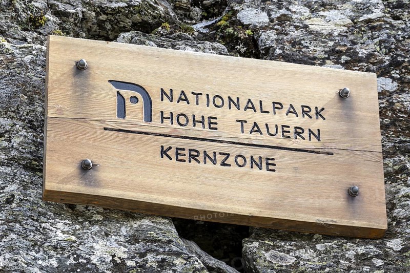 Wooden sign on rock, inscription Hohe Tauern National Park core zone, Schober group, Hohe Tauern National Park, Carinthia, Austria