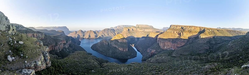 Panorama, sunset at Blyde River Canyon with Three Rondawels peak, view of canyon with Blyde River and table mountains in the evening light, canyon landscape, Panorama Route, Mpumalanga, South Africa