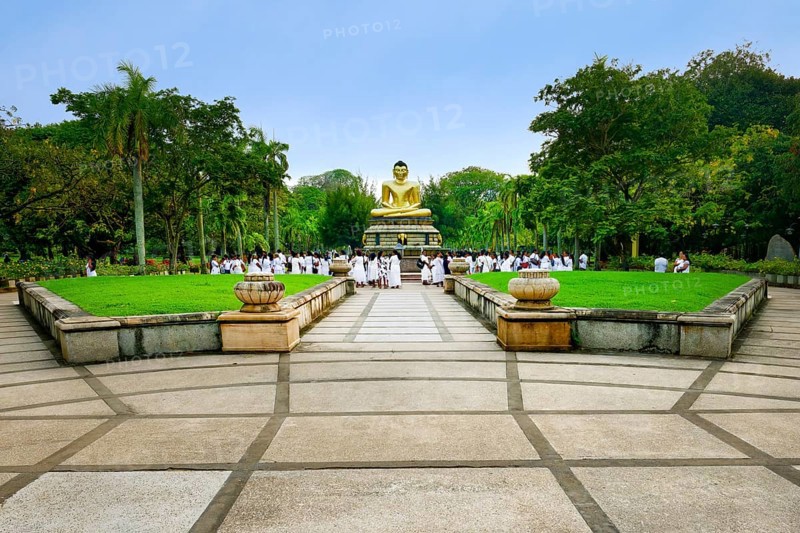 Pilgrims in front of a Buddha statue, Colombo, Sri Lanka