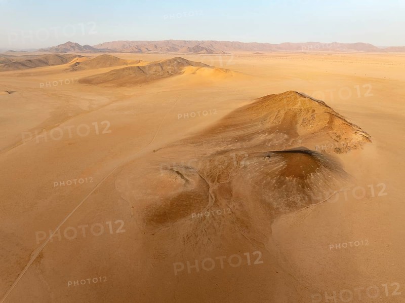 Arid plains, and bare mountain ridges in the Tsondab Valley in the Namib Desert. Aerial view. Drone shot. Namibia