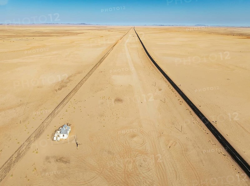 The long abandoned Garum train station and the B4 tarred road in the southern Namib Desert. Aerial view. Drone shot. Namibia
