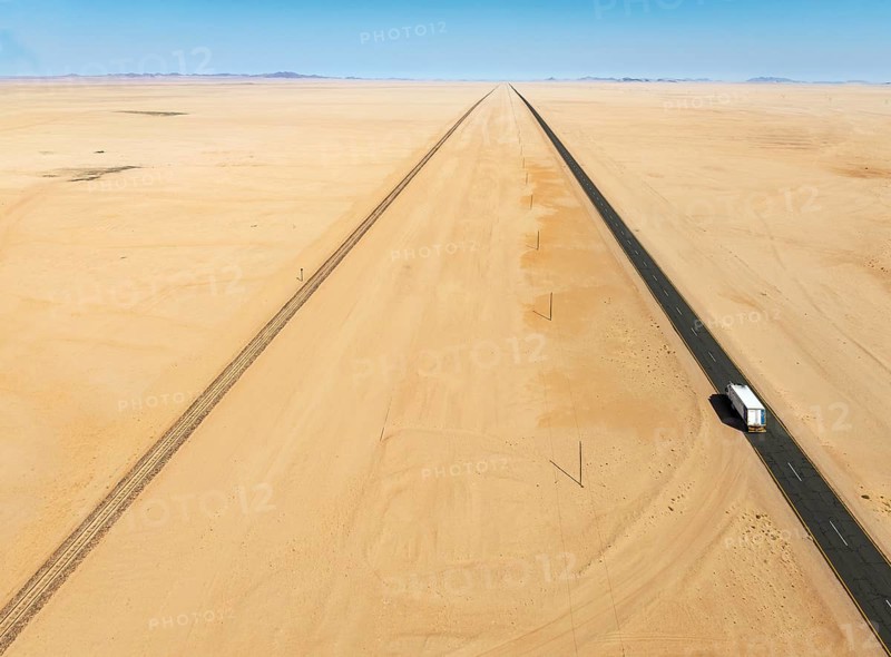 Rails and the B4 tarred road between Aus and Lüderitz in the southern Namib Desert. Aerial view. Drone shot. Namibia