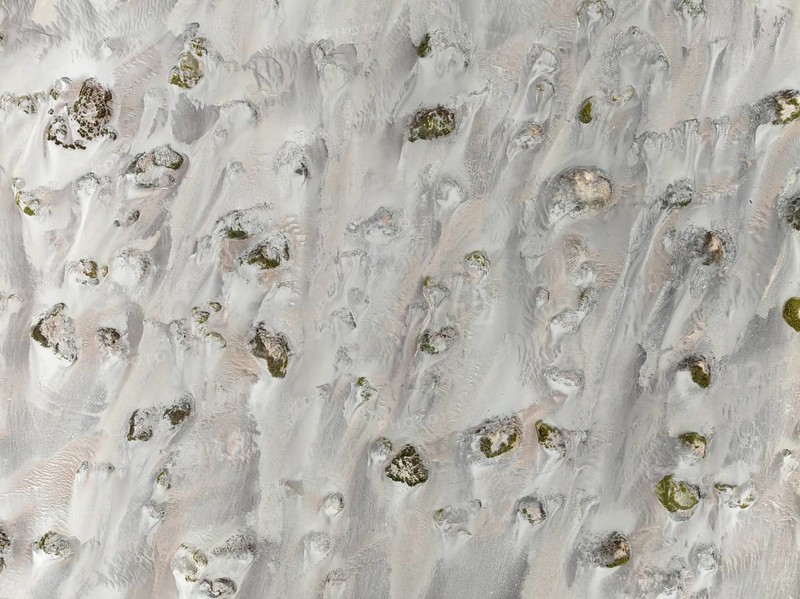 Small sand heaps form around the sparse vegetation in the Namib Desert. Aerial view. Drone shot. Skeleton Coast National Park, Namibia