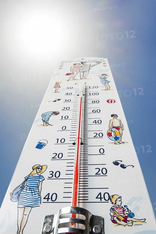 Worm's-eye view of thermometer measures extremely hot temperature of 38 degrees Celsius, 38 °C, 100 °F during heatwave, heat wave in summer