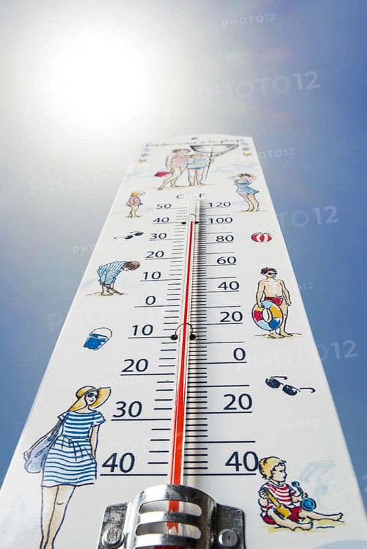 Worm's-eye view of thermometer measures extremely hot temperature of 40 degrees Celsius, 40 °C, 100 °F during heatwave, heat wave in summer