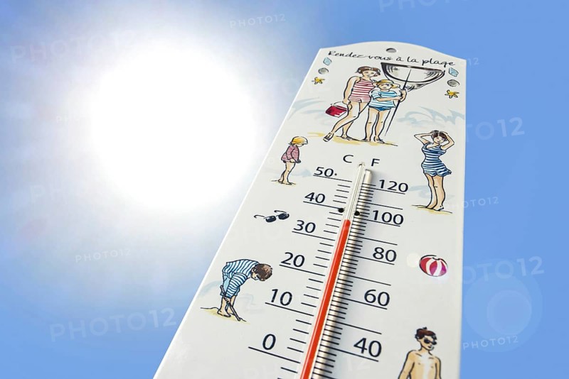 Worm's-eye view of thermometer measures extremely hot temperature of 36 degrees Celsius, 36 °C, 90 °F during heatwave, heat wave in summer